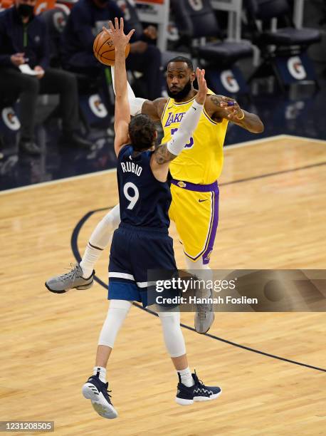 LeBron James of the Los Angeles Lakers passes the ball against Ricky Rubio of the Minnesota Timberwolves during the first quarter at Target Center on...