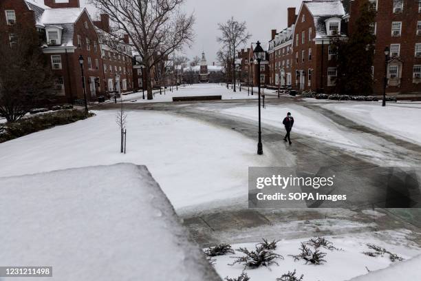 Student walks around Ohio University Campus during snowstorm Uri. Snowstorm Uri swept across the United States from February 12th to the 16th...