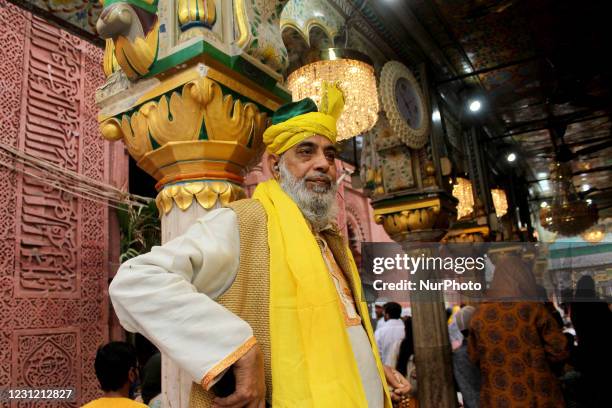 Devout is seen at the Nizamuddin Dargah embraced in yellow on the occasion of 'Sufi Basant' celebrations on February 16, 2021 in New Delhi, India....