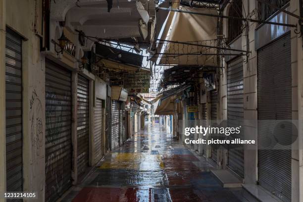 February 2021, Greece, Athen: The shutters of the shops in a narrow alley in the Athens district of Monastiraki are closed. A strict lockdown has...