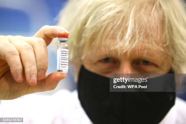 British Prime Minister Boris Johnson poses with a vial of the Oxford/AstraZeneca vaccine during a visit to the vaccination centre at Cwmbran Stadium...