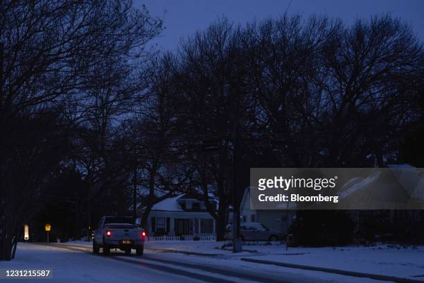 Truck drives down the street during a power outage in McKinney, Texas, U.S., on Tuesday, Feb. 16, 2021. The energy crisis crippling the U.S. Showed...