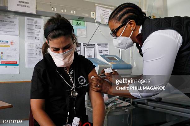 Doctor Anike Baptiste receives a dose of the Johnson & Johnson vaccine against the COVID-19 coronavirus from Mokgadi Malebye, a professional nurse,...