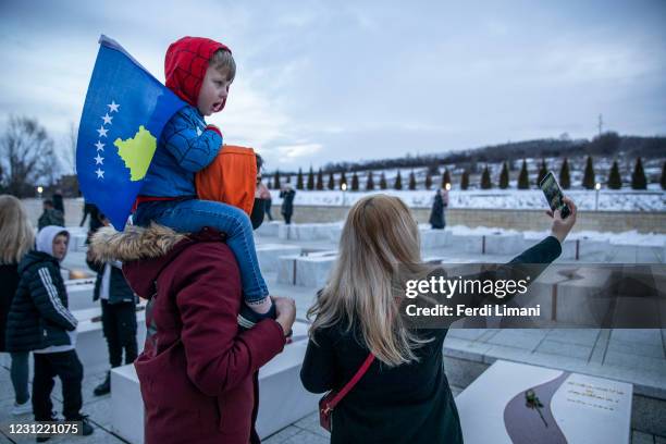 Kosovo Albanian boy holds a Kosovar flag at the Jashari martyrs family in Adem Jashari Memorial on February 17, 2021 in Prekaz, Kosovo. A decade...