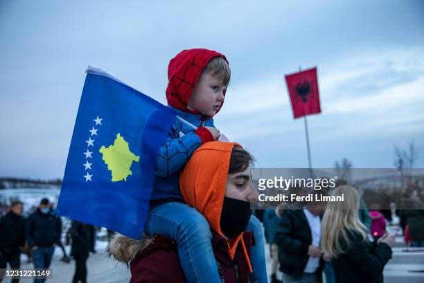 Kosovo Albanian boy holds a Kosovar flag at the Jashari martyrs family in Adem Jashari Memorial on February 17, 2021 in Prekaz, Kosovo. A decade...