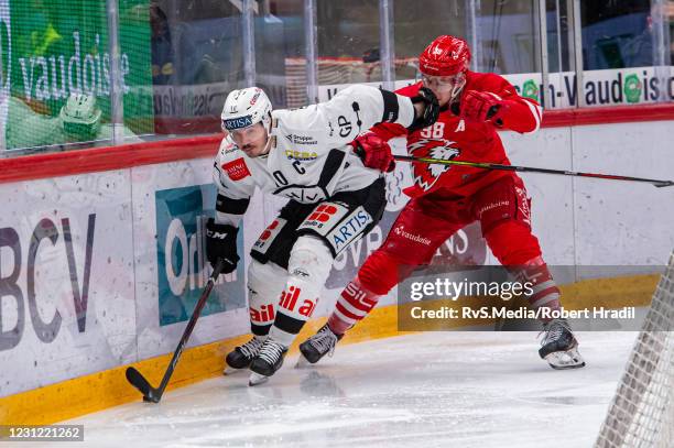 Alessio Bertaggia of HC Lugano battles for the puck with Lukas Frick of Lausanne HC during the Swiss National League match between Lausanne HC and HC...