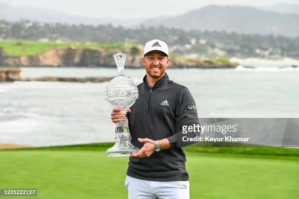 Daniel Berger smiles with the trophy following his victory in the final round of the AT&T Pebble Beach Pro-Am at Pebble Beach Golf Links on February...