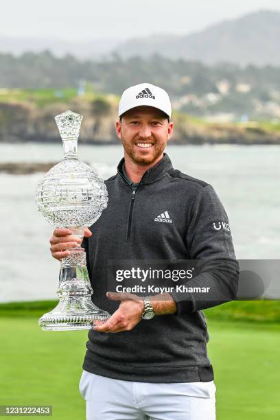 Daniel Berger smiles with the trophy following his victory in the final round of the AT&T Pebble Beach Pro-Am at Pebble Beach Golf Links on February...