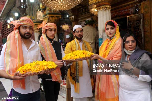 Devouts throng the Nizamuddin Dargah embraced in yellow on the occasion of 'Sufi Basant' on February 16, 2021 in New Delhi, India. The Hindu spring...