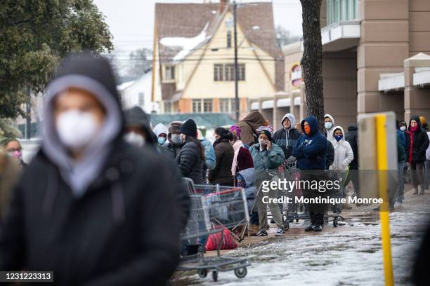 People wait in long lines at an H-E-B grocery store in Austin, Texas on February 17, 2021. Millions of Texans are still without water and electric as...
