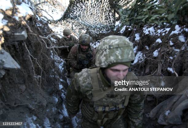 Ukrainian servicemen stand in position on the front line with Russia-backed separatists in Donetsk region on February 16, 2021. - Ukraine has been...