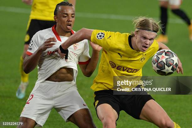 Dortmund's Norwegian forward Erling Braut Haaland challenges Sevilla's French defender Jules Kounde during the UEFA Champions League round of 16...