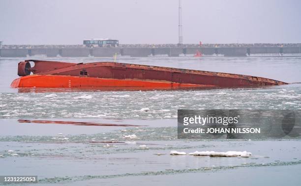 The capsized dredger Margrethe Fighter remains afloat upside down in the harbor of Trelleborg, Sweden, after an accident on February 17, 2021. - Two...