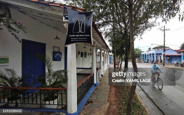 Man passes by a closed handicraft shop in Vinales, Cuba, on January 28, 2021. - At the foot of the majestic rock formations of Vinales, the terraces...