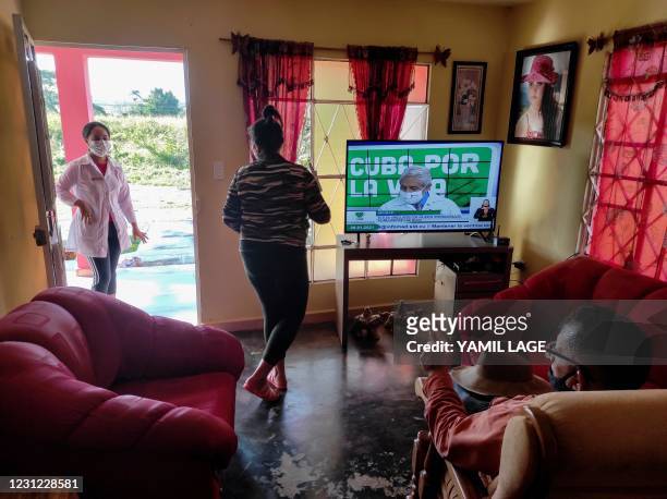 Carlos Millo, owner of a lodging for tourists, talks to a doctor in his house in Vinales, Cuba, on January 29, 2021. - At the foot of the majestic...