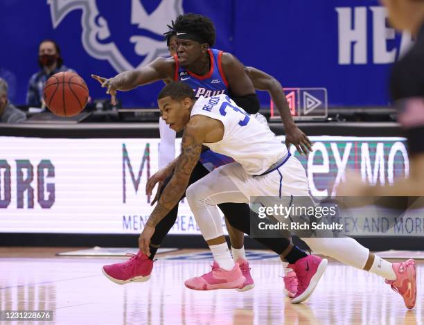Ray Salnave of the DePaul Blue Demons battles Shavar Reynolds, Jr. #33 of the Seton Hall Pirates for a loose ball during the first half of an NCAA...