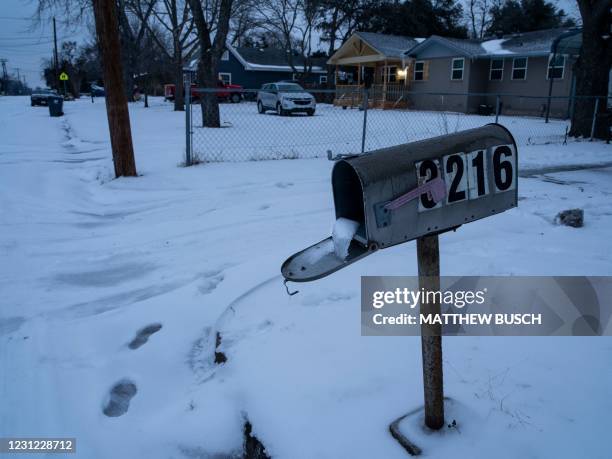 Mailbox is seen frozen in a snow covered neighborhood in Waco, Texas as severe winter weather conditions over the last few days has forced road...