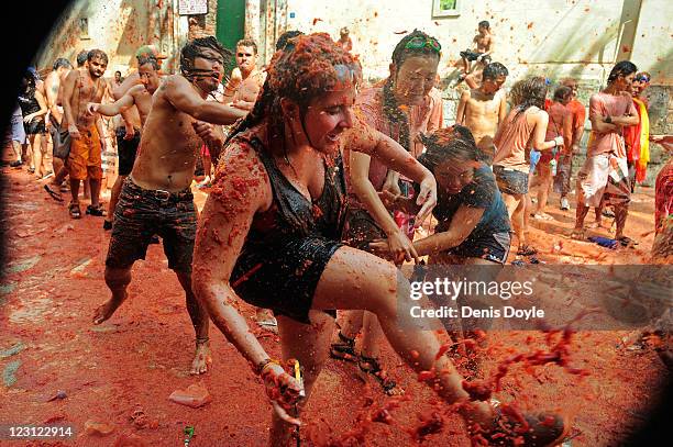 Revellers play in a pool of tomato juice during the annual tomatina on August 31, 2011 in Bunol, Spain. An estimated 35,000 people threw 120 tons of...