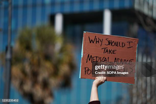 Demonstrator holding a placard expressing her opinion outside the South Carolina Statehouse during a press conference and protest by Democrats who...