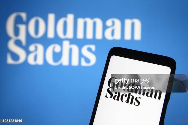 In this photo illustration the Goldman Sachs logo of the U.S. Investment bank is seen on a smartphone and a pc screen.