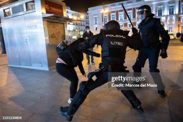 Riot police beating a woman during clashes in a demonstration against the imprisonment of Spanish rapper Pablo Hasel for some song lyrics and tweets...