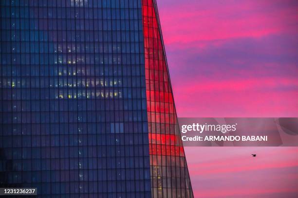 The facade of the headquarters of the European Central Bank is tinged by the colours of the rising sun in Frankfurt am Main, western Germany, on...