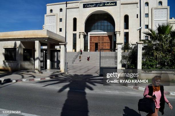 People leave the Algerian Dar Al-Baida tribunal in the capital Algiers on February 18 where the trial of men accused of murdering French mountaineer...