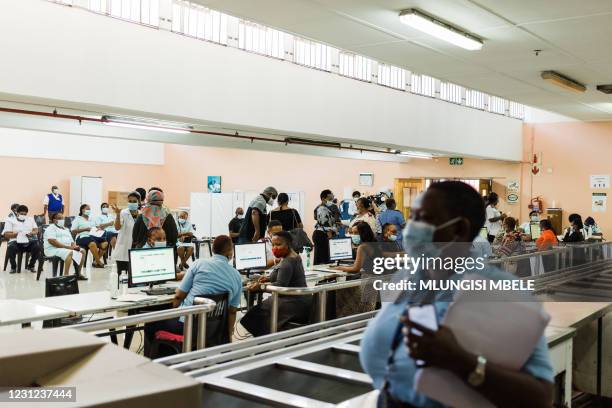Healthcare workers await to register at a vaccination site to receive a dose of the Johnson & Johnson vaccine against the COVID-19 coronavirus as...