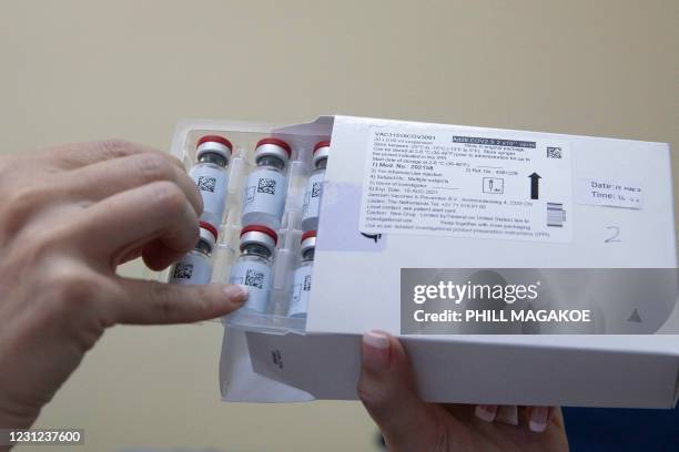 Healthcare worker holds vials containing doses of the Johnson & Johnson vaccine against the COVID-19 coronavirus as South Africa proceeds with its...
