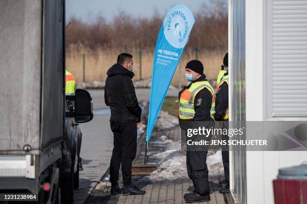 Officers of the Federal Police control a car driver at the German-Czech border in an attempt to stem the spread of the new coronavirus variants, in...