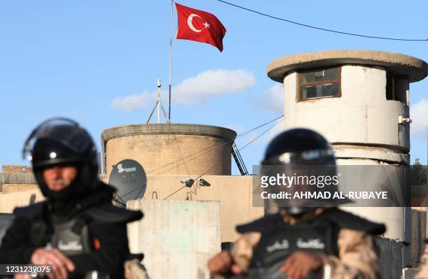 Iraqi riot police protect the Turkish embassy in Baghdad on February 18, 2021 after calls on social media to gather outside the Turkish embassy to...