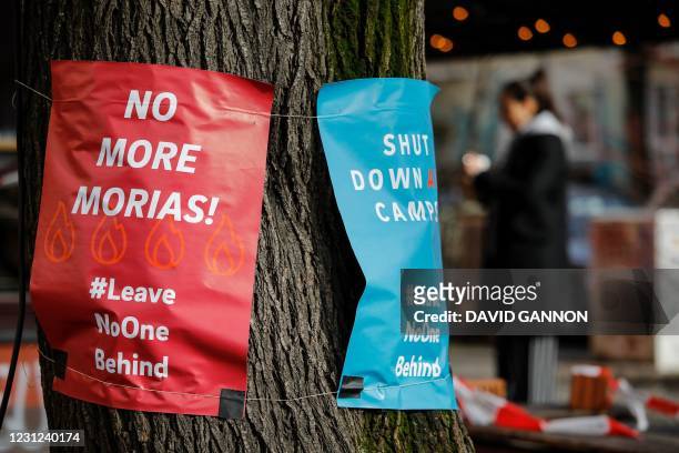 Posters calling for "No more Morias" referring to the Moria refugee camp on the Greek island of Lesbos which burned down, are hung on a tree on...