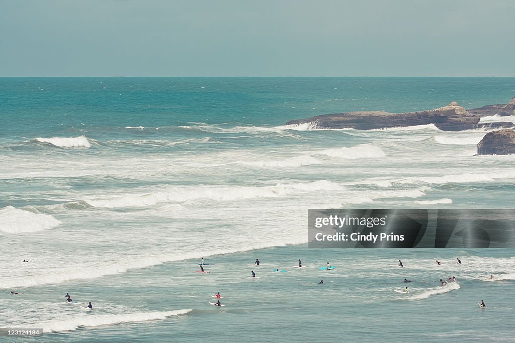 Surfers lying in ocean