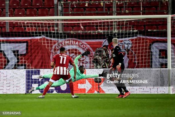 Eindhoven's Swiss goalkeeper Yvon Mvogo concedes a goal during the UEFA Europa League round of 32 first leg football match between Olympiacos FC and...