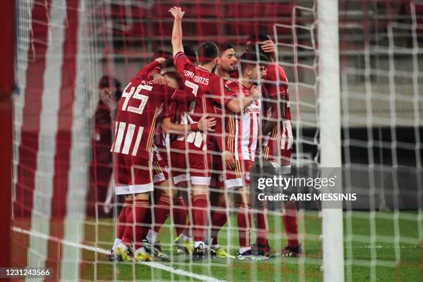 Olympiacos' players celebrate after scoring a goal during the UEFA Europa League round of 32 first leg football match between Olympiacos FC and PSV...