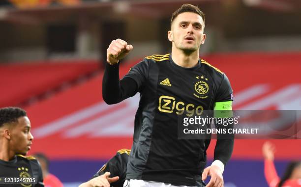 Ajax' forward Dusan Tadic celebrates scoring his team's first goal during the UEFA Europa League round of 32 first leg football match between Lille...