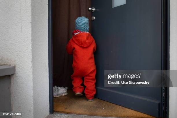 Bonn, Germany In this photo illustration a child walks into a front door on February 17, 2021 in Bonn, Germany.