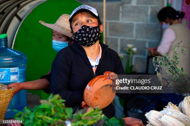 Leticia, a member of the collective Mujeres de la Tierra, works in the kitchen, in Milpa Alta, Mexico City, on February 16, 2021. - The collective...