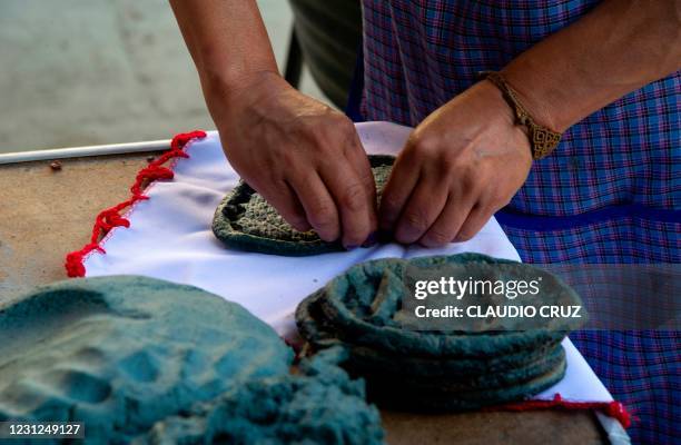 Ana, a member of the collective Mujeres de la Tierra, prepares Mexican traditional tortillas, in Milpa Alta, Mexico City, on February 16, 2021. - The...