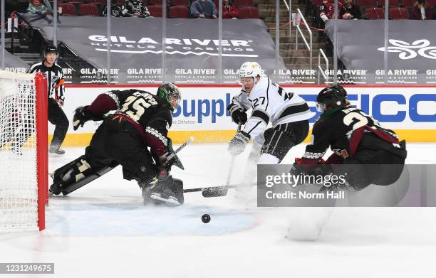 Goalie Darcy Kuemper of the Arizona Coyotes deflects the puck away from the net on the shot attempt by Austin Wagner of the Los Angeles Kings as...