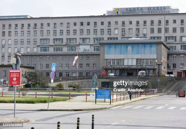 Woman wearing a face mask is photographed outside Santa Maria University Hospital, as Portuguese lockdown continues, on February 17, 2021. Portugal,...