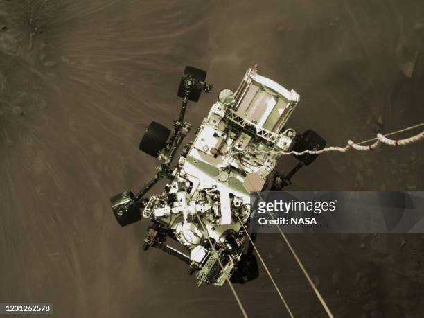 In this handout image provided by NASA, still image is part of a video taken by several cameras aboard the descent stage as NASA’s Perseverance rover...