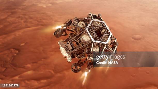 In this concept illustraion provided by NASA, NASA’s Perseverance rover fires up its descent stage engines as it nears the Martian surface to land in...