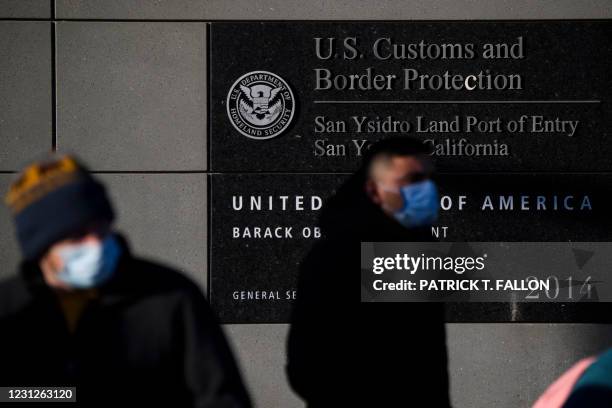 People exit a pedestrian crossing at the US Customs and Border Protection San Ysidro Port of Entry at the US Mexico border on February 19, 2021 in...