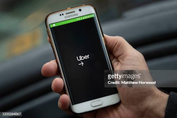 In this photo illustration an Uber app is seen on February 19, 2021 in Cardiff, Wales. Uber drivers in the UK have won a six-year battle to be...