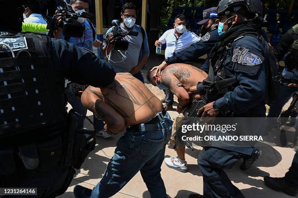 Members of the criminal gang Mara Salvatrucha are escorted by officers of the National Police in Tegucigalpa on February 19 after the dismantling of...