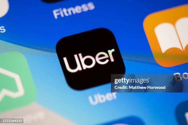 In this photo illustration a close-up of an Uber app is seen on an iPhone on February 19, 2021 in Cardiff, Wales. Uber drivers in the UK have won a...