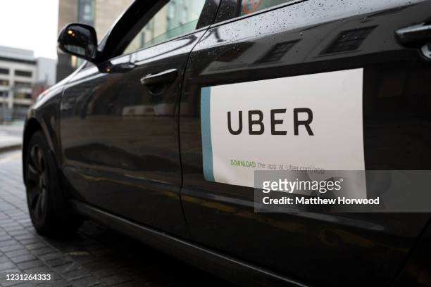Close-up of an Uber sticker on the side of a car on February 19, 2021 in Cardiff, Wales. Uber drivers in the UK have won a six-year battle to be...