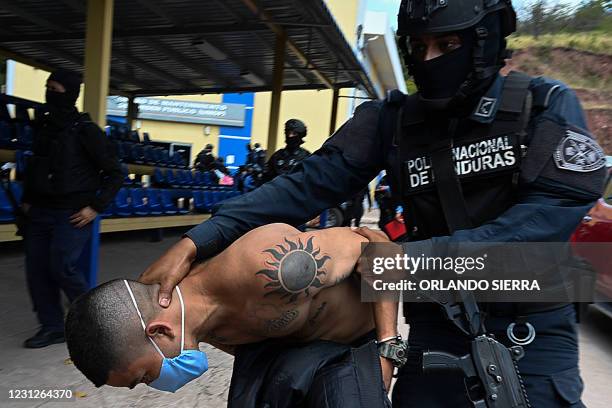 Members of the criminal gang Mara Salvatrucha are escorted by officers of the National Police in Tegucigalpa on February 19 after the dismantling of...