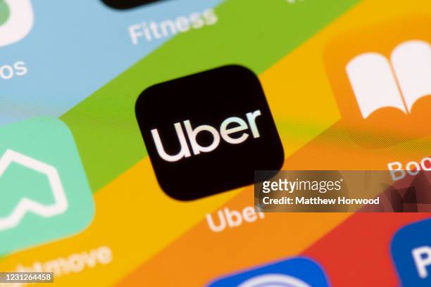 In this photo illustration a close-up of an Uber app is seen on an iPhone on February 19, 2021 in Cardiff, Wales. Uber drivers in the UK have won a...